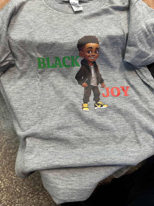 Heather grey t shirt with word black in green text and a black boy wearing open black zipped hoodie, white shirt and black pants with black and yellow kicks with the word Joy in red text. Melanin apparel. Black boy joy