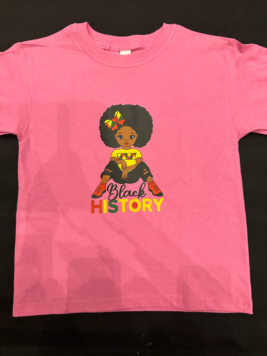 Pink shirt with black girl with Afro with red yellow and green bow in her hair wearing a yellow shirt with red and green markings on the chest and black ripped jeans and red shoes with black in black cursive text and History is red, yellow and green block text. Melanin Apparel. 