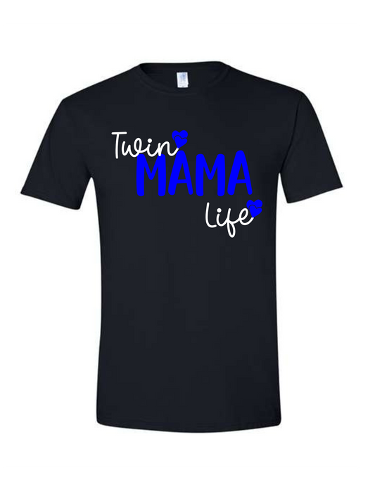 Black shirt with Blue Mama text bold in the centre and twin in script text at the top and life under Mama in white with double hearts at end of twin and life.